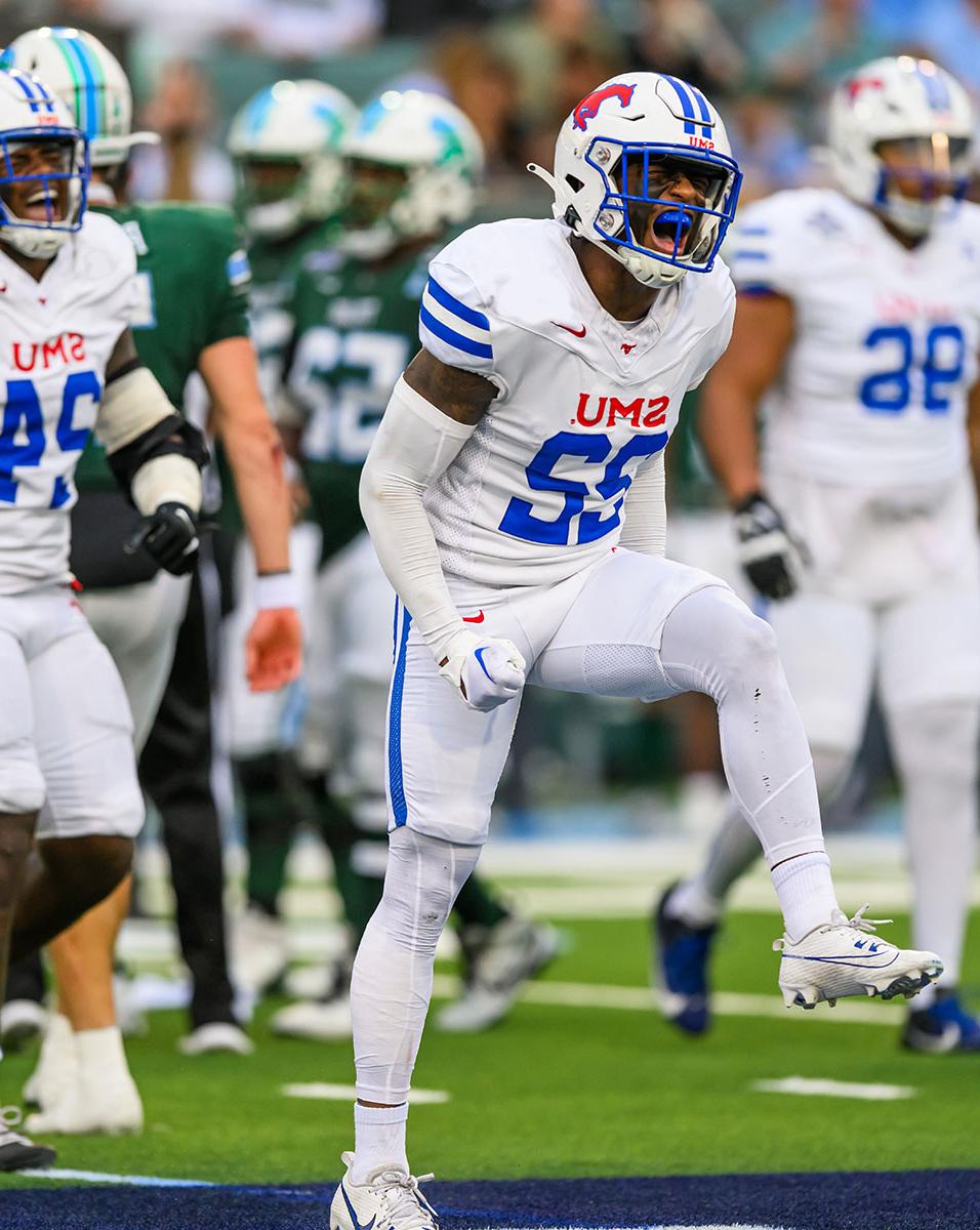 SMU football players exult after a successful play